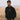 Man wearing black Bean There “Seek The Best” sweater and cap standing in a grassy field