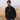 Man wearing black Bean There “Seek The Best” sweater and cap standing in a grassy field