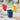 Blue Bialetti Bicchierini espresso cup filled with coffee, with colourful cups in the background