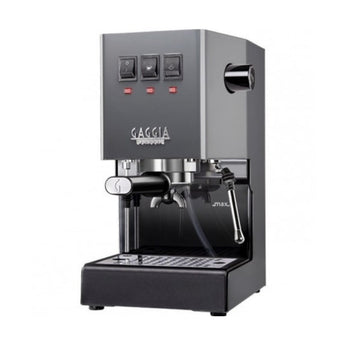 Angled view of grey Gaggia Classic espresso machine with control switches and portafilter