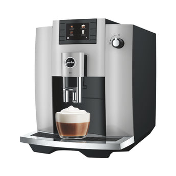 Jura E6 automatic coffee machine preparing a creamy cappuccino with milk foam