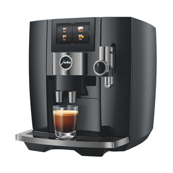 Front view of Jura J10 automatic coffee machine in black with touchscreen display and espresso in glass cup