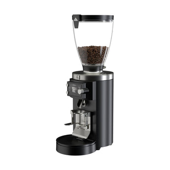 Black Mahlkönig E65W Grind-By-Sync grinder with coffee beans in the hopper on a white background