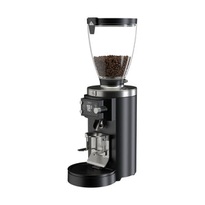 Black Mahlkönig E65W Grind-By-Sync grinder with coffee beans in the hopper on a white background