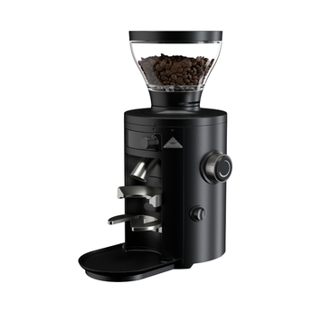 Angled side view of the black Mahlkönig X54 On-Demand Grinder showcasing the bean hopper, grind chute, portafilter holder, and side grind adjustment knob.