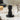 Timemore Impulse Impact Tamper on coffee counter with espresso cup and portafilter in background