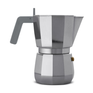 Grey Alessi Moka 6-cup espresso maker side view on a white background, showing the grey handle, polished faceted body and gold safety valve.