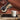 Alessi Induction Moka coffee maker pouring fresh espresso-style coffee into a white mug