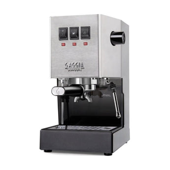 Angled view of stainless steel Gaggia Classic espresso machine highlighting portafilter, control switches, and steam wand