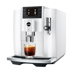 Jura E8 automatic espresso machine with freshly brewed black coffee