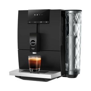 JURA ENA 4 automatic coffee machine side profile brewing espresso into glass cup with crema