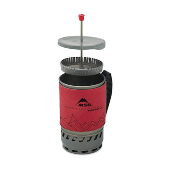 MSR WindBurner 1.0L stove system with coffee press plunger inserted into pot, insulated red sleeve and heat exchanger base visible