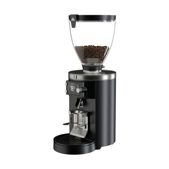 Black Mahlkönig E80W Grind-By-Sync grinder with clear bean hopper, 18 g display and portafilter holder on a white background