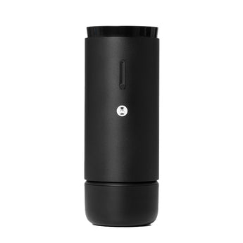 Front view of the black Whirly portable electric coffee grinder with power button and logo detail