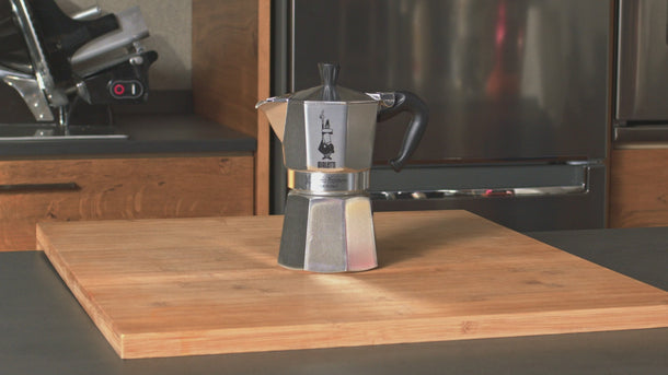 Step-by-step demonstration showing how to fill, assemble, heat and pour coffee from a Bialetti Moka Express stovetop coffee maker.